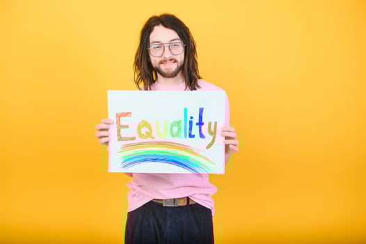 Hands of gay man holding lgbt banner on rainbow flag background lgbt symbol photo