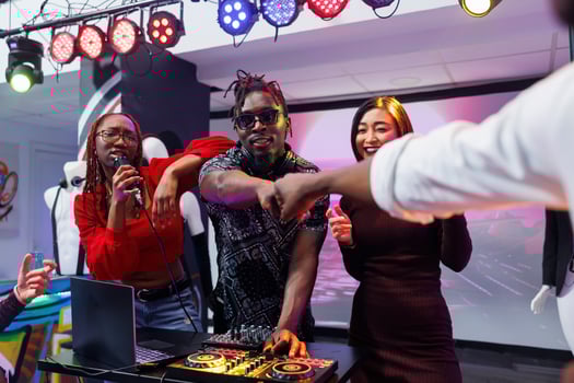 Musicians performing on stage, interacting with crowd and bumping fists. Electronic music band using dj station for mixing tracks live and engaging audience at nightclub party photo