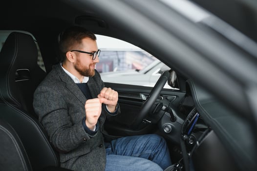 His true love. Portrait of a mature man smiling happily sitting in a brand new car photo