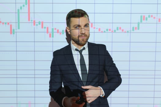 Portrait of concerned European businessman thinking in blurry office with double exposure of falling financial chart. Concept of crisis and stock market. photo