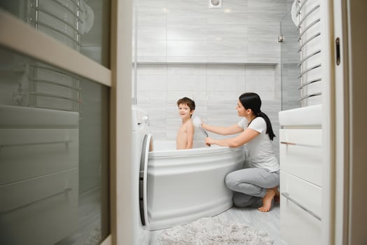 Mother And Son Having Fun At Bath Time Together photo