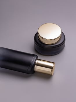 Set of skin care products. Luxury face cream in a jar and toner in a bottle. Cosmetics packaging mockup photo