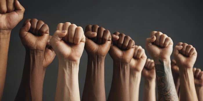 AI generated Multi ethnic people raised their fists in the air. A sign of unity, human rights and equality. photo