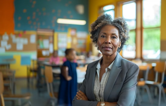 AI generated Portrait of a poised African American teacher with crossed arms standing in a vibrant classroom. photo
