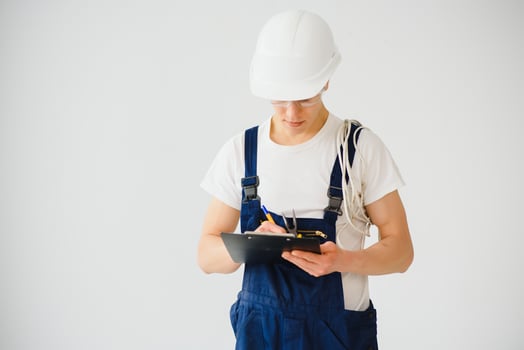 handsome electrical engineer holding clipboard on white background photo