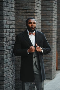 Fashion portrait of a handsome young African American business man walking outdoors in a casual pose. photo