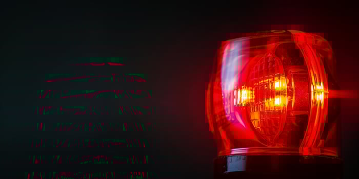 AI Generated flashing red warning light on dark background with copy space photo