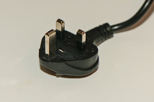 black plug from English standard socket on the table 2 photo