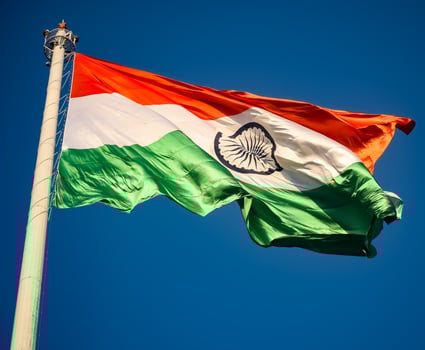 India flag flying high at Connaught Place with pride in blue sky, India flag fluttering, Indian Flag on Independence Day and Republic Day of India, tilt up shot, Waving Indian flag, Har Ghar Tiranga photo