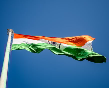 India flag flying high at Connaught Place with pride in blue sky, India flag fluttering, Indian Flag on Independence Day and Republic Day of India, tilt up shot, Waving Indian flag, Har Ghar Tiranga photo