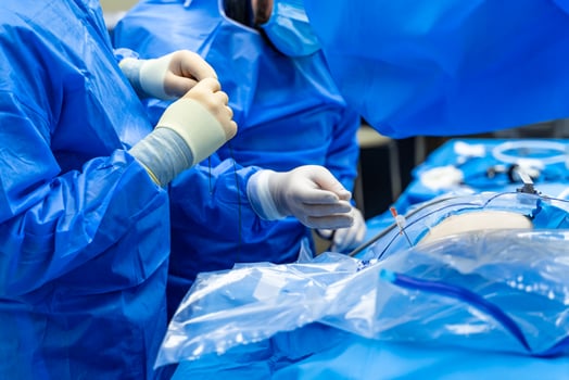 Medical team performing surgical operation in bright modern surgery room. Operating theatre. Selective focus. Emergency room. Closeup photo