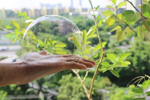 Soapsuds on palm. Bubble in hand. photo
