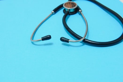 statoscope closeup on blue background, top view.Global healthcare concept.Statoscope stylish doctor with heart on blue background photo