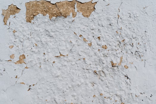 Textured wall. Peeling plaster on the white wall. Aged wall covering. Textured surface in the surrounding environment. Renovation required photo