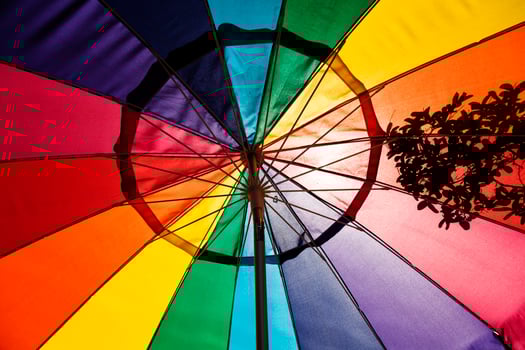 Sunlight Shining Through Multi-Colored Patio Umbrella photo