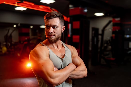 Strong man with muscular body type training in sports hall. photo