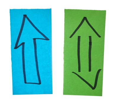 Two sheets of paper with arrows drawn with black marker photo