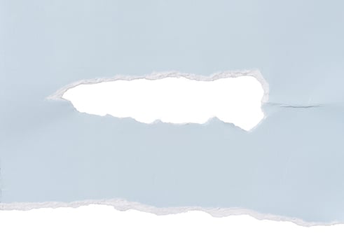 Torn piece of blue cardboard with a hole on an isolated background photo