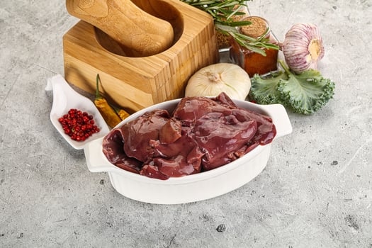 Raw uncooked chicken liver in the bowl photo