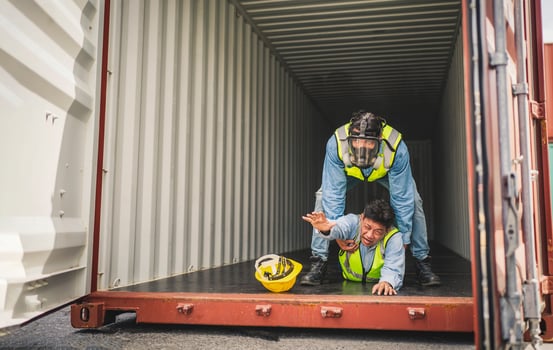Engineer wear PPE urgently assisted the male technique inside container as Chemical spill in the container shipping industry photo