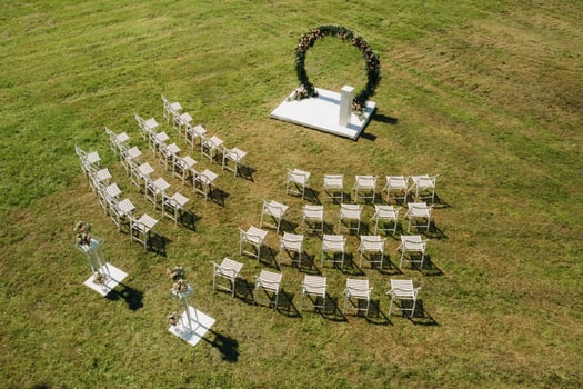 Wedding ceremony on the street on a green lawn with white chairs photo