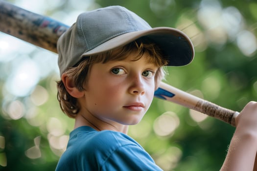 AI generated close up child wearing baseball cap and holding baseball bat in park, a boy playing baseball outdoor photo