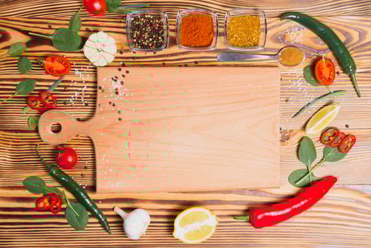 Composition with wooden board and ingredients for cooking on table photo