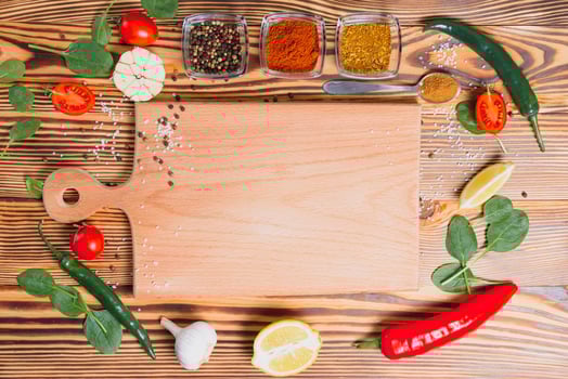 Composition with wooden board and ingredients for cooking on table photo