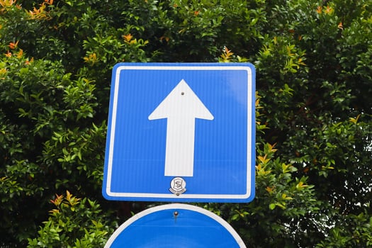 a blue directional arrow sign. surabaya, indonesia - 21 february 2024 photo