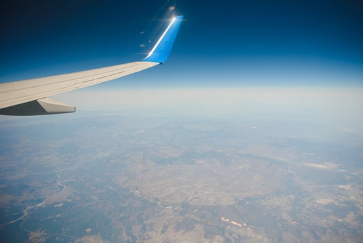 Clouds and sky as seen through window of an aircraft photo