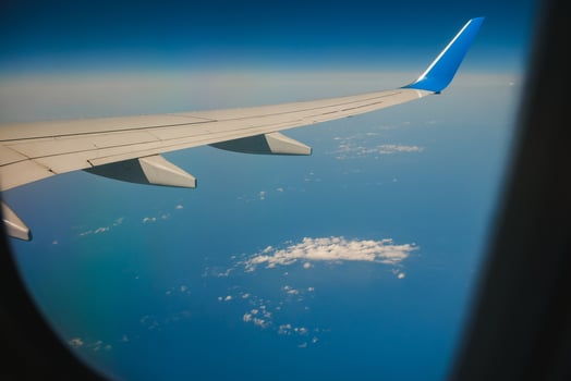 Clouds and sky as seen through window of an aircraft photo