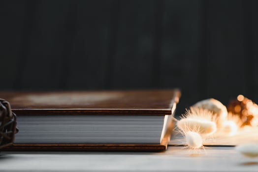 Luxury wooden photo book on natural background. Family memories photobook. Save your summer vacation memories. Photo album wedding photoalbum with wooden cover.