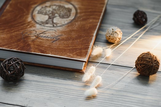 Luxury wooden photo book on natural background. Family memories photobook. Save your summer vacation memories. Photo album wedding photoalbum with wooden cover.