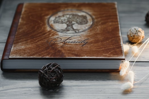 Luxury wooden photo book on natural background. Family memories photobook. Save your summer vacation memories.