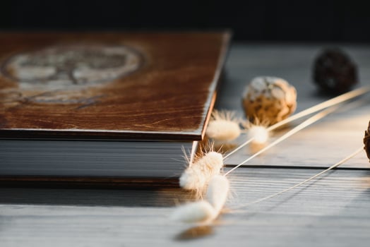Luxury wooden photo book on natural background. Family memories photobook. Save your summer vacation memories. Photo album wedding photoalbum with wooden cover.
