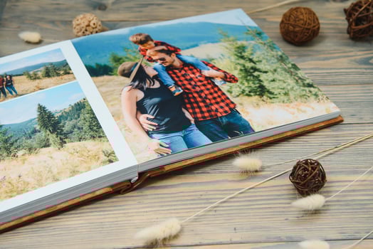 Luxury wooden photo book on natural background. Family memories photobook. Save your summer vacation memories.