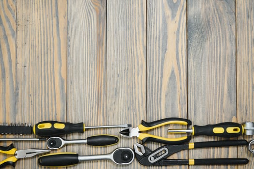 Set of tools over a wood panel with space for text photo