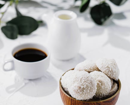 candies in white glaze and coconut flakes photo