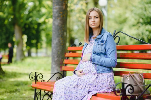 Beautiful pregnant woman relaxing in the park photo