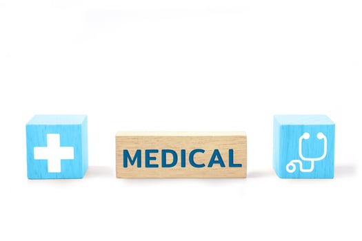 Wooden block with the word MEDICAL and medical icons. Health care, health insurance and treatment concept. photo