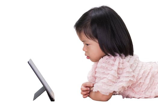 Asian child Girl reading on tablet at school. Preschool kid using a computer at home. Isolated on white background. Baby aged 4 years old. photo