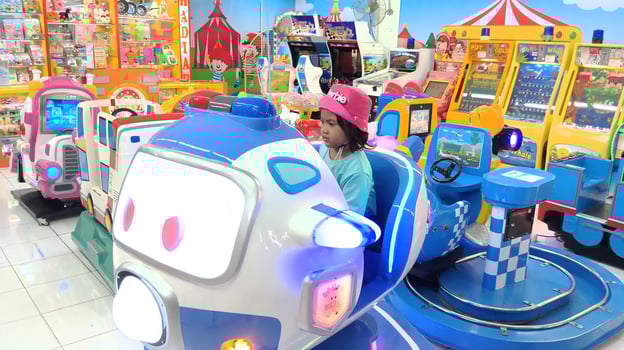 Semarang, Indonesia - February, 2024 - A girl rides an airplane game on the playground photo