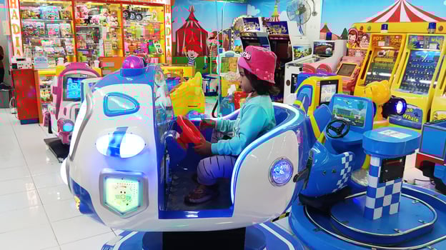 Semarang, Indonesia - February, 2024 - A girl rides an airplane game on the playground photo
