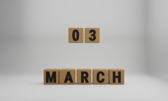 wooden cubes with arranged letters. March and 03 on blurry white background photo