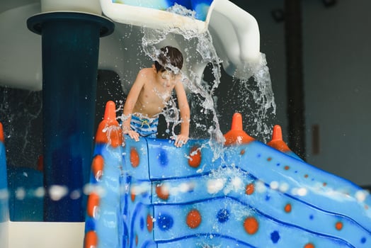 Boy having fun in aqua park photo