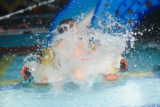 Boy having fun in aqua park photo