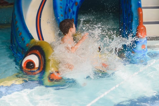 Boy having fun in aqua park photo