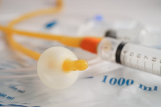 Foley catheter and urine drainage bag collect urine for disability or patient in hospital. photo