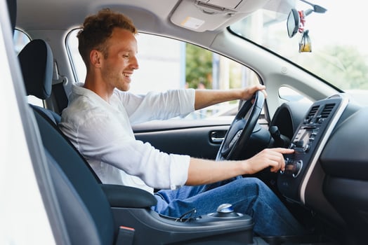 Man sitting at the wheel of electric car photo