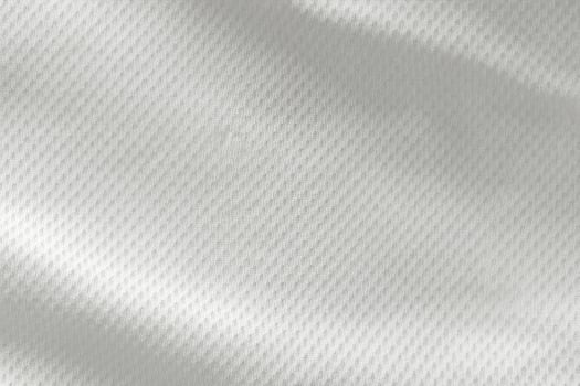 A close-up top view of the texture of a white sports fabric jersey football shirt. photo